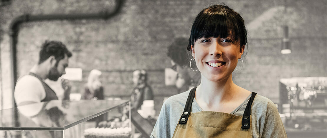 woman in apron at coffee shop