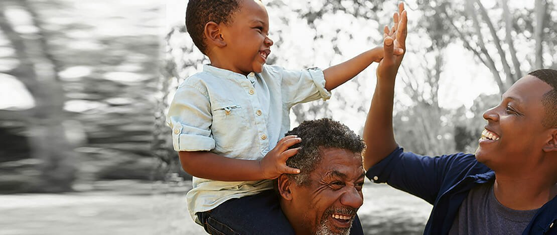 child on grandfather's shoulders